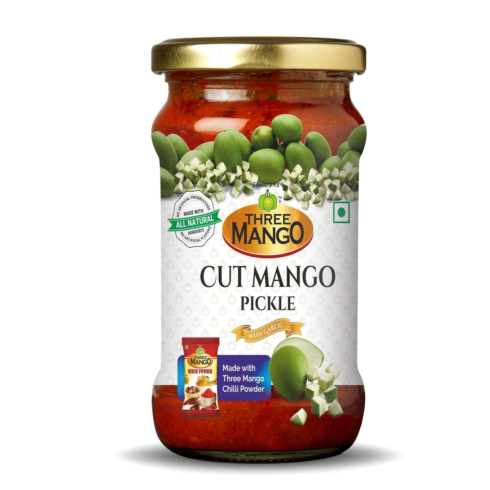 A jar of Three Mango Cut Mango Pickle with the label showing the product name and images of mangoes. The jar has a gold-colored lid and is presented with a graphic of spiced mangoes.