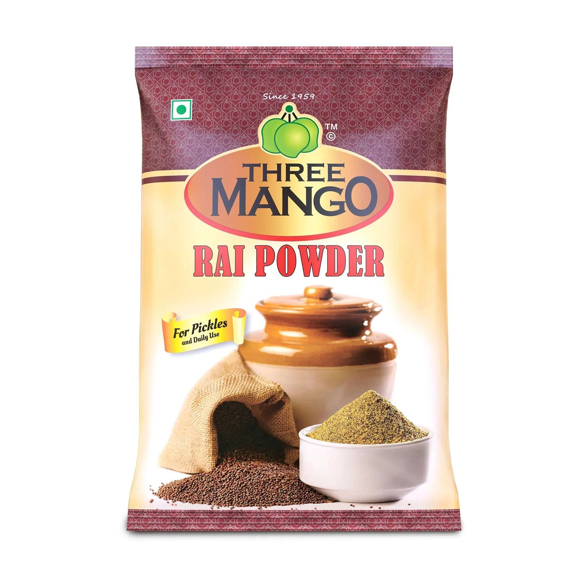 Three Mango Rai Powder 500g pack with mustard seeds, ground rai, and a ceramic pickle jar, labeled for pickles and daily use