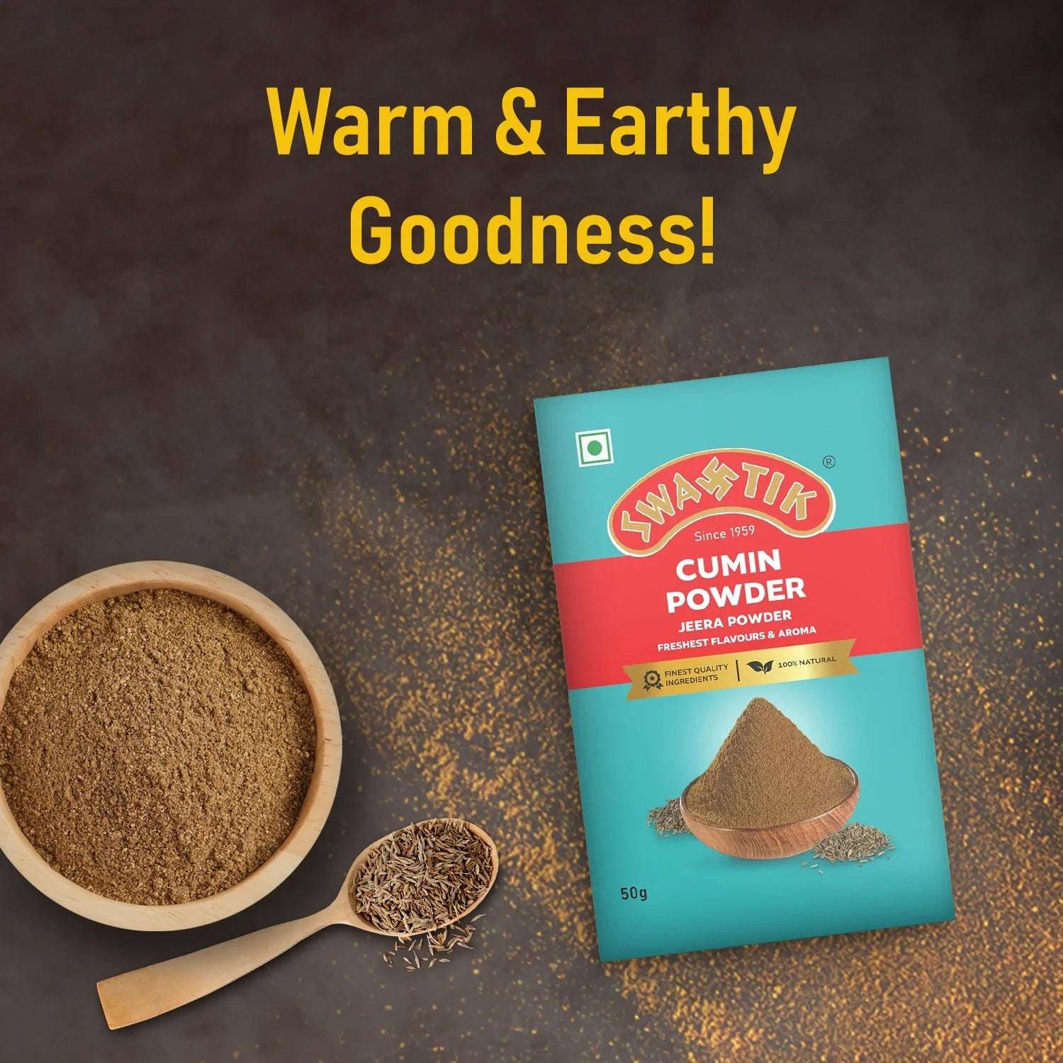Swastik Cumin Powder pack placed with a bowl and spoon of cumin powder and seeds on dark background with the tagline 'Warm & Earthy Goodness'