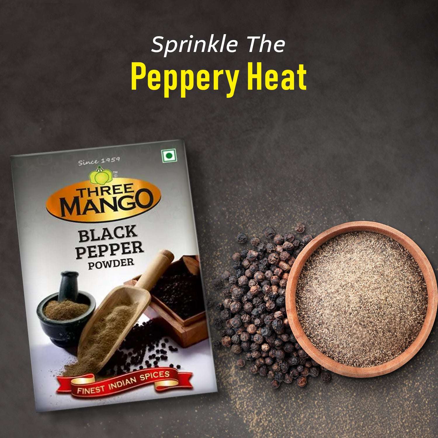 Three Mango Black Pepper Powder pack with whole black peppercorns and a bowl of freshly ground powder on dark background – highlighting spice freshness and intensity for cooking.