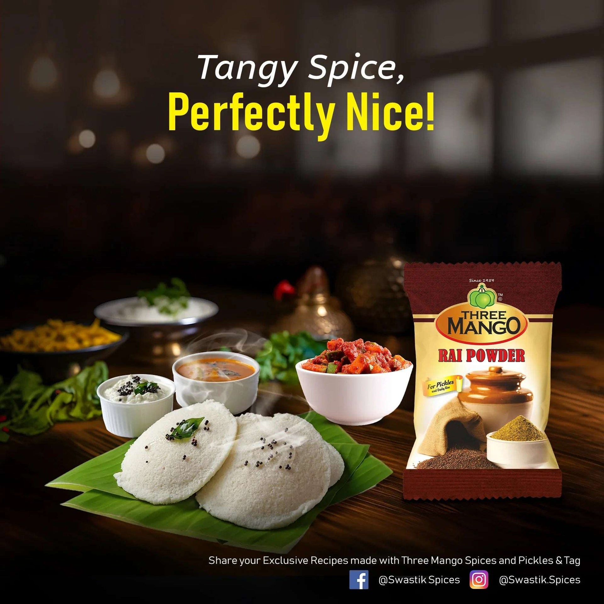 Three Mango Rai Powder pack beside a South Indian meal featuring idlis, sambar, chutney, and pickle with the tagline ‘Tangy Spice, Perfectly Nice!’